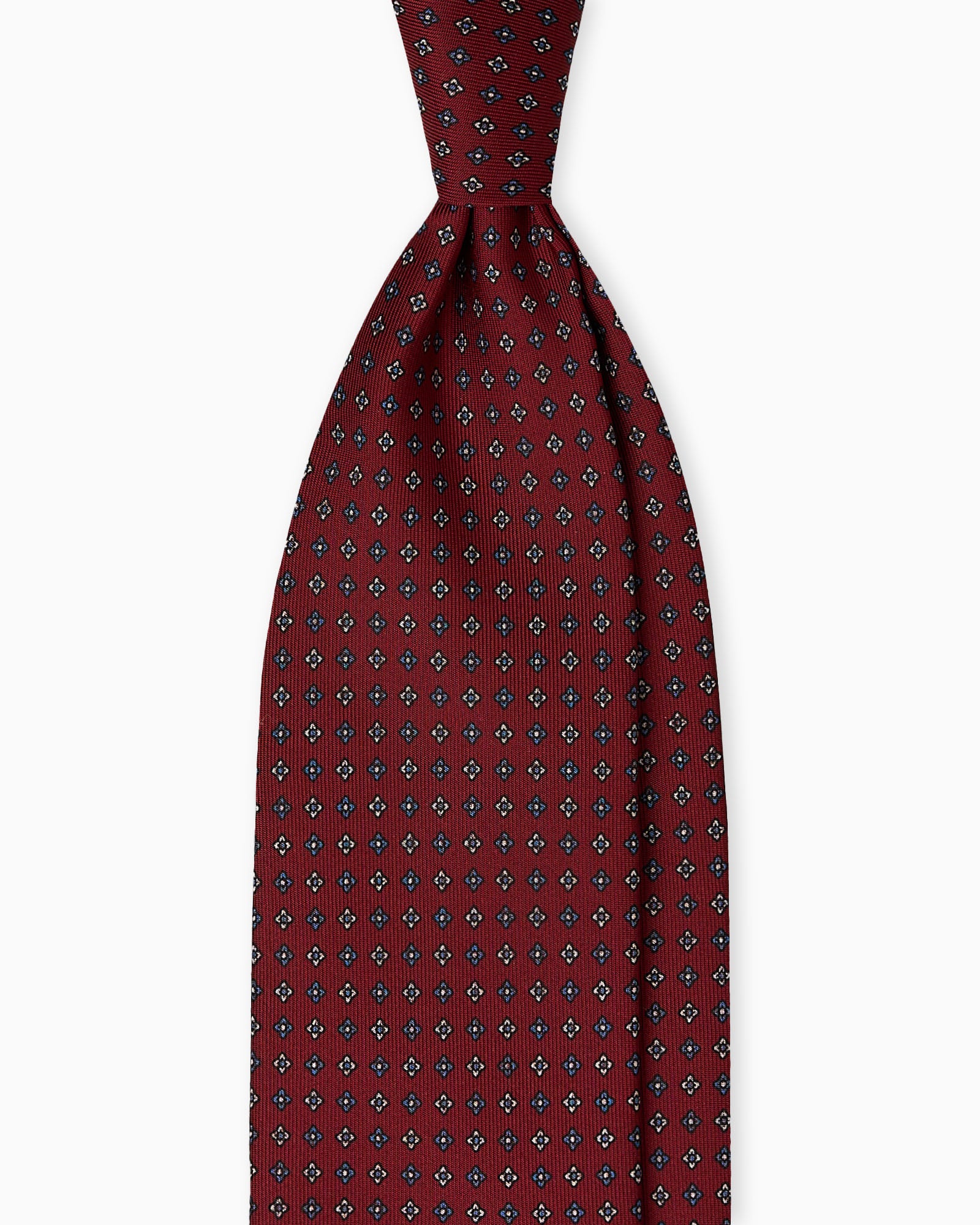 Handmade English silk tie in burgundy with floral pattern, artisanal Italian silk tie crafted for business attire and formal occasions.