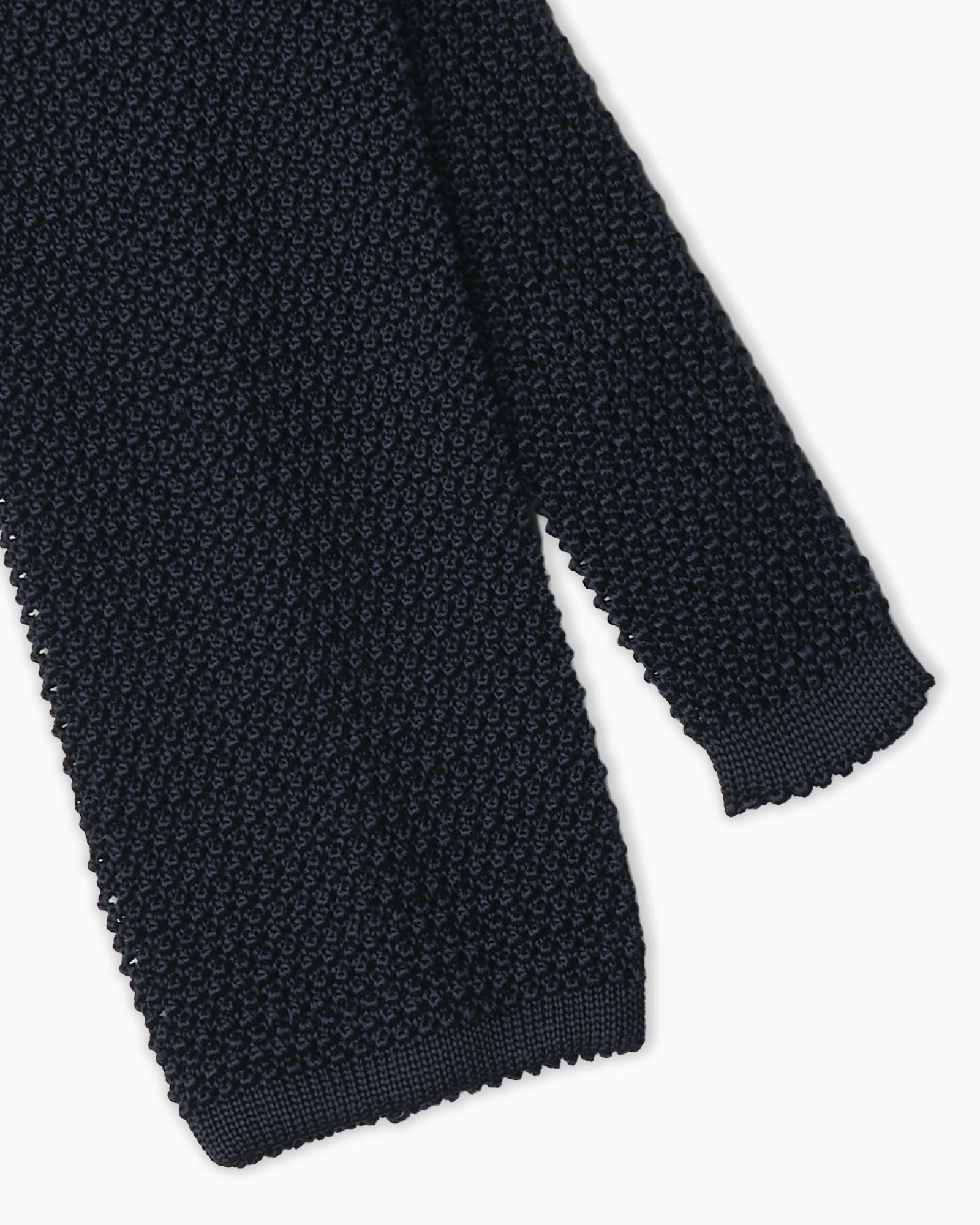 Blue knitted tie crafted in Italy with crochet weave detail